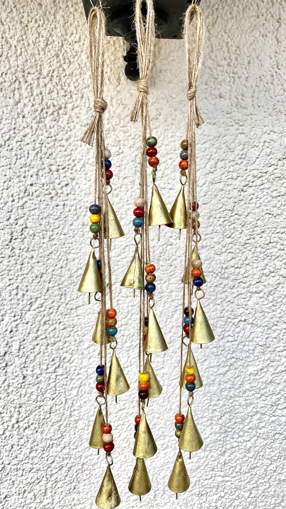 Wind chime made from vintage bells and colorful ceramic beads for home and garden decoration. Chime with witch bell. Cowbell Boho decoration