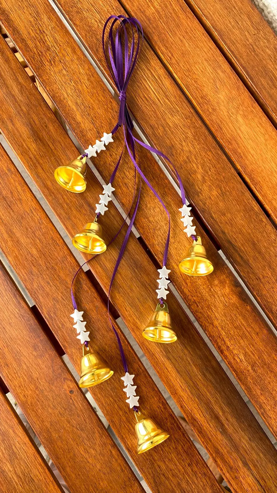 Wind chime with golden bells for decoration and home protection. Bell chime for your home or as a gift. Witch bells with stars. Boho